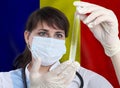 Scientist woman with test tube Coronavirus or COVID-19 against Romania flag. Research of viruses in laboratory for prevention Royalty Free Stock Photo