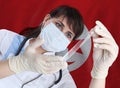 Scientist woman with test tube Coronavirus or COVID-19 against Tunisia flag. Research of viruses in laboratory Royalty Free Stock Photo