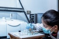 Scientist Women Check Sample in Vials for Analysis by Fourier Transform Infrared Spectroscopy FTIR Instrument