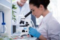 Scientist during work with microscope at modern biological laboratory