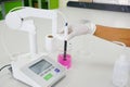 The scientist work at with pH meter