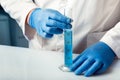 Scientist working whit test tube graduated cylinder analyzing fluids in laboratory Royalty Free Stock Photo