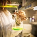 Scientist works with a green aqueous solution Royalty Free Stock Photo