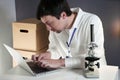 Scientist at workspace in laboratory with microscope, computer, and laboratory tools. Bio technology. Med students stuff. Medical Royalty Free Stock Photo