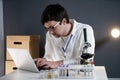 Scientist at workspace in laboratory with microscope, computer, and laboratory tools. Bio technology. Med students stuff. Medical Royalty Free Stock Photo