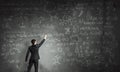Scientist writing formulas on chalkboard Royalty Free Stock Photo