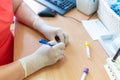 Scientist writing on test tubes in a laboratory clinic on blurred background