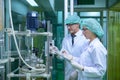 Scientists and assistants are in the machine room extracting oil and cannabis seeds. Inspecting cannabis oil extractor before