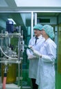 Scientists and assistants are in the machine room extracting oil and cannabis seeds. Inspecting cannabis oil extractor before