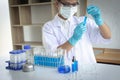 Scientists are carrying blue chemical test tubes to prepare for the determination of chemical composition and biological mass in a