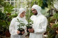 Scientists in clean suit holding potted plants Royalty Free Stock Photo