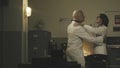 Scientists dancing together in a vintage style lab