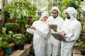 Scientists discussing over technologies at greenhouse Royalty Free Stock Photo