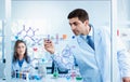 Scientists drawing chemical formulas on clear board in science laboratories Royalty Free Stock Photo