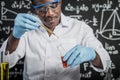 Scientists drop yellow and red chemicals into the glass at the laboratory