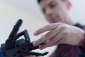 Scientists engineers designing small human robot, setting artificial intelligence humanoid robot. Artificial intelligence,