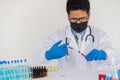 Scientists are examining liquid samples in a laboratory for chemical science testing with colorful liquids in test tubes. Royalty Free Stock Photo