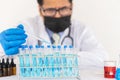 Scientists are examining liquid samples in a laboratory for chemical science testing with colorful liquids in test tubes. Royalty Free Stock Photo