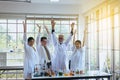 Scientists hands rais up together,Group of diversity people teamwork in laboratory,Success and reserch working