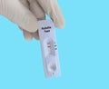 Scientists or Lab Technologists hold a device of Rubella IgG, IgM rapid screening test.