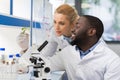 Scientists Looking At Sample Of Plant Working In Genetics Laboratory, Mix Race Couple Of Researchers Analyzing Result Of Royalty Free Stock Photo