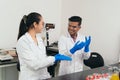 Scientists preparing for laboratory work. Lab technicians putting on lab gloves