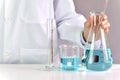 Scientists researching in laboratory, Chemist holding scientific glassware equipment