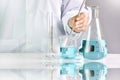 Scientists researching in laboratory, Chemist holding scientific glassware equipment