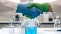Scientists shake hands over laboratory experiment Royalty Free Stock Photo
