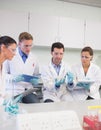 Scientists with tablet PC working on an experiment at lab Royalty Free Stock Photo