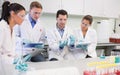 Scientists with tablet PC working on an experiment at lab Royalty Free Stock Photo