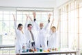 Scientists team raise up your hand,Group of people teamwork in laboratory,Successful and reserch working