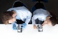 Scientists in uniforms working with microscopes in laboratory Royalty Free Stock Photo