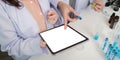 Scientists Utilize Tablet and Lab Resources for Collaborative Research Methodology