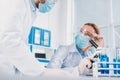 scientists in white coats, medical gloves and goggles making scientific research together Royalty Free Stock Photo