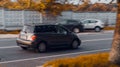 Scion xA car is driving on the road at sunset time. Rear side view of gray hatchback in motion on the blurred background of autumn Royalty Free Stock Photo