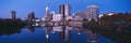 Scioto River and Columbus Ohio skyline, the capital city, at dusk with lights on