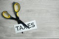 Scissor Cutting the Word Taxes. Royalty Free Stock Photo