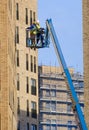 Glasgow, UK, 13th January 2024, Scissor lift being operated by construction workmen for safe access at height