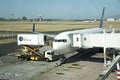 Scissor lift and catering truck alongside a passenger jet