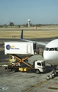 Scissor lift and catering truck alongside a passenger jet