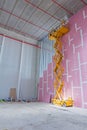 Scissor lift platform on a construction site. Royalty Free Stock Photo