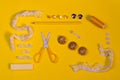 Scissors, buttons, zipper, thread and thimble on yellow Royalty Free Stock Photo