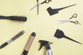 Scissors, comb and other hair styling tools on yellow background Royalty Free Stock Photo