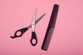 Scissors and comb on a pink background, hairdresser toolsn Royalty Free Stock Photo