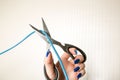Scissors cut connection wire on a beige background Royalty Free Stock Photo