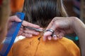 Scissors cut the little girls hair.