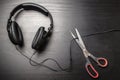 Scissors cut the wire from the headphones, and thus stop the very loud illegal pirated music Royalty Free Stock Photo