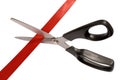 Scissors cutting red ribbon or tape, isolated white background Royalty Free Stock Photo