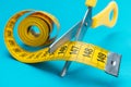Scissors cutting yellow measuring tape dieting concept Royalty Free Stock Photo